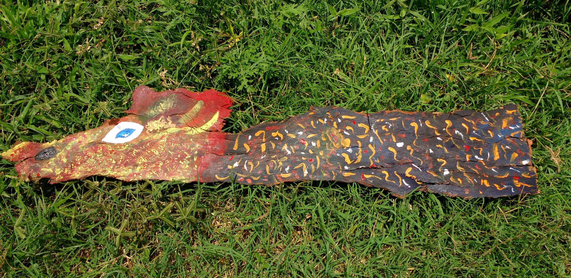 Semi-Abstract art of a dragon painted on tree bark by Shaunak Taunk